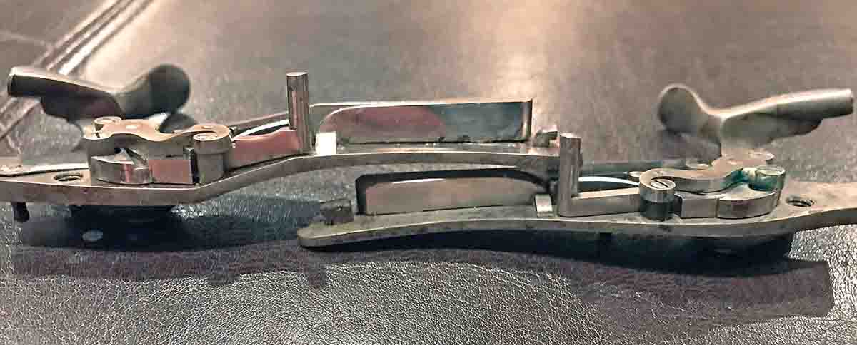 Henry “cranked” lock on left, standard flat lockplate on right.